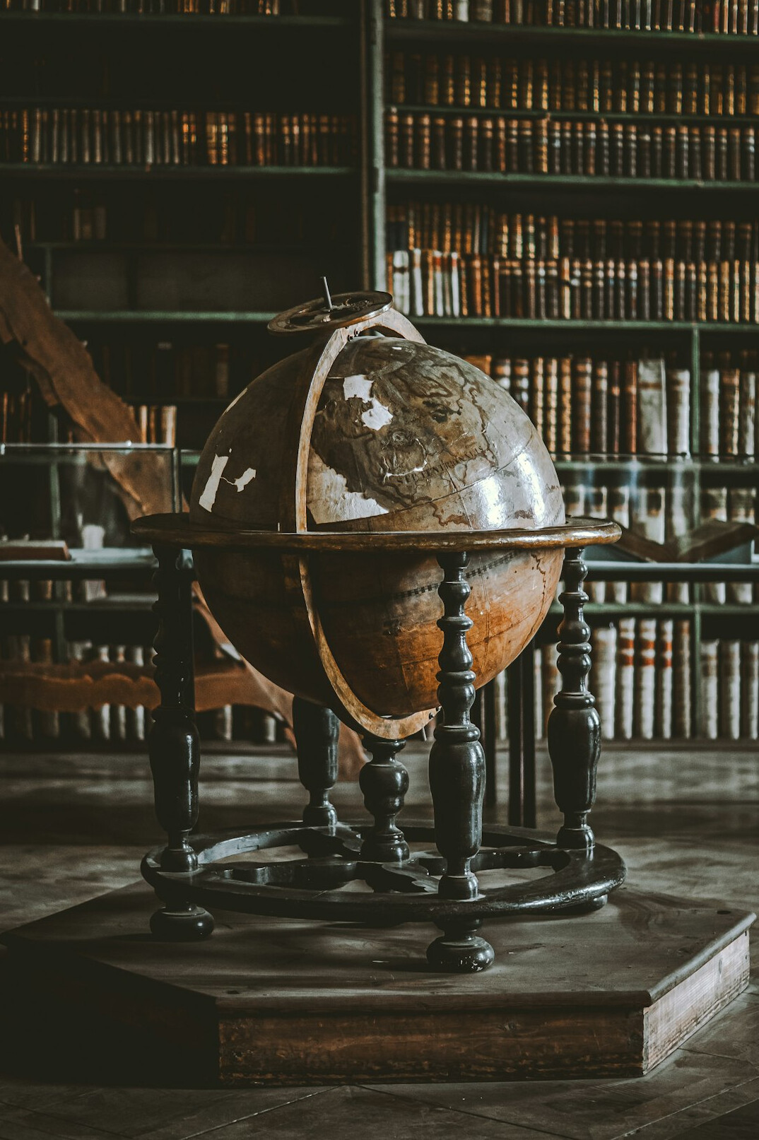 Antique map and brass compass on a wooden table