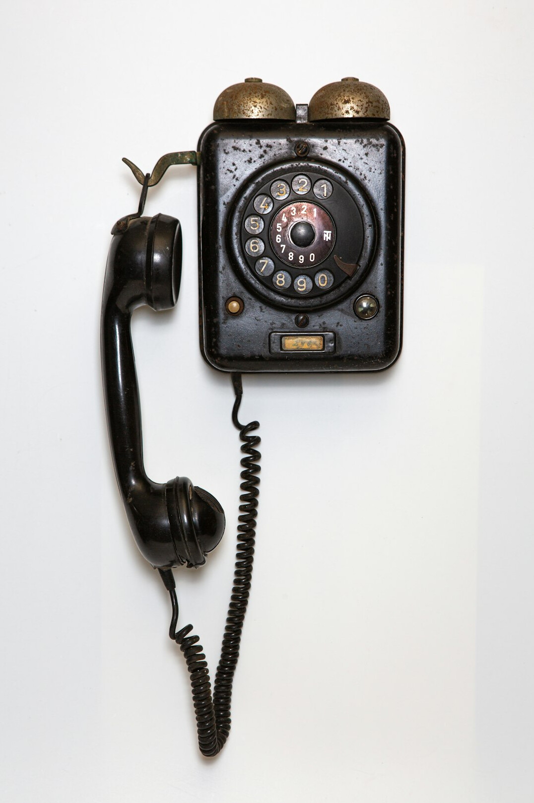 Old rotary telephone on a wooden desk