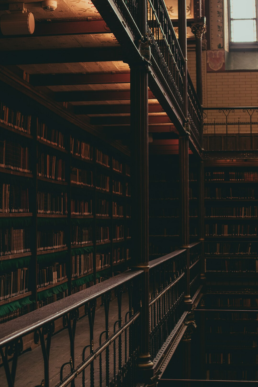 Interior of an old library with tall wooden bookshelves